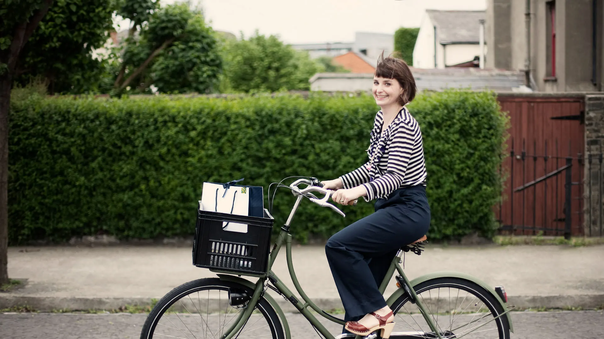 branding, lifestyle, riding in the street, bicycle, young woman, stripes shirt